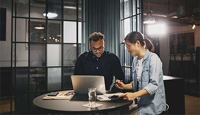 a man and a woman on a laptop